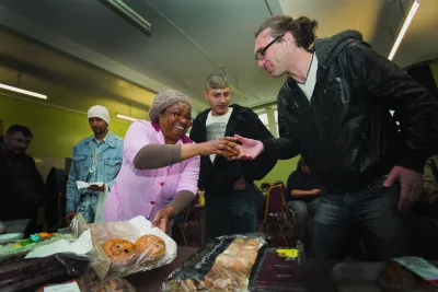 Volunteers serving food at a drop in